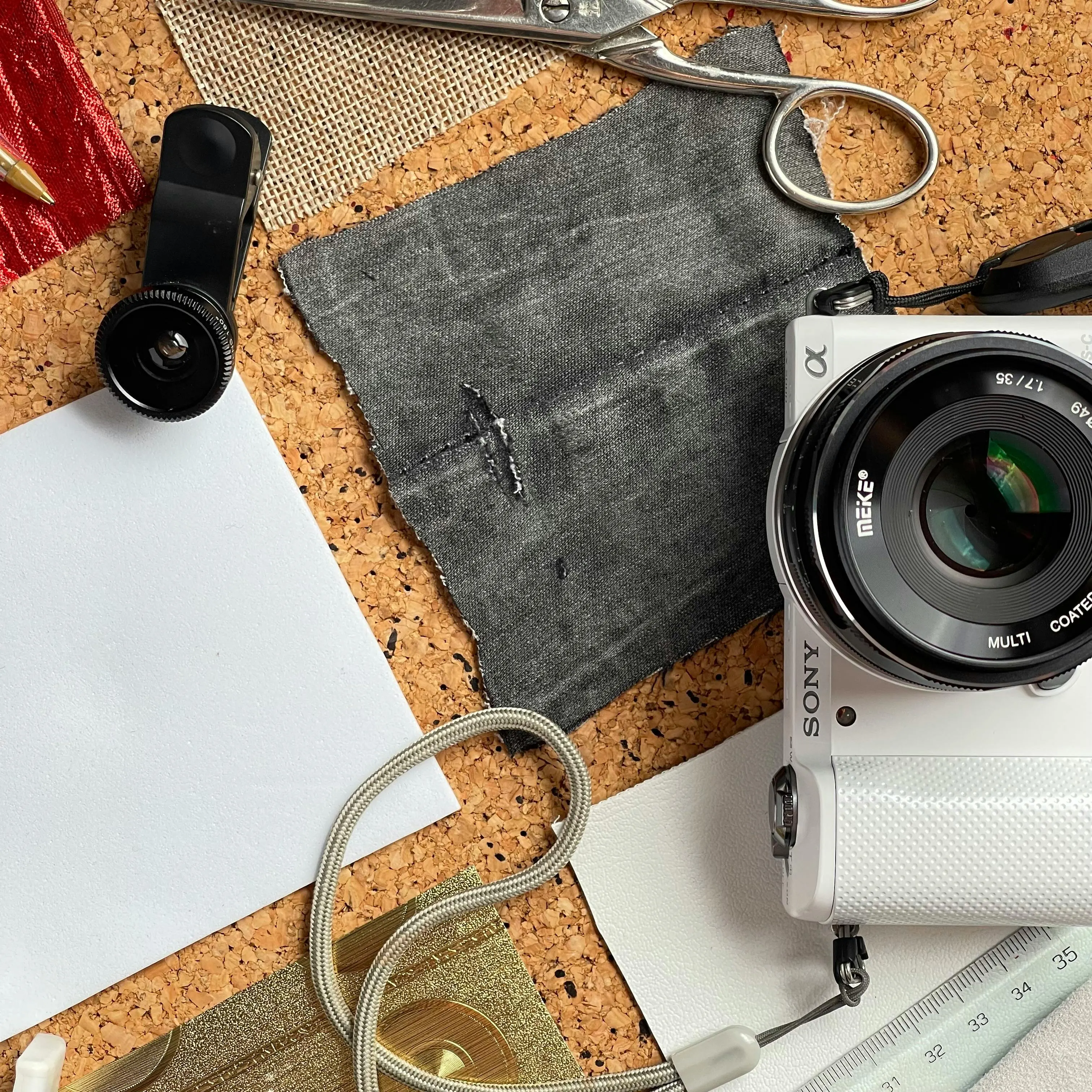 Minimal packing scene with neutral clothing and travel notebook