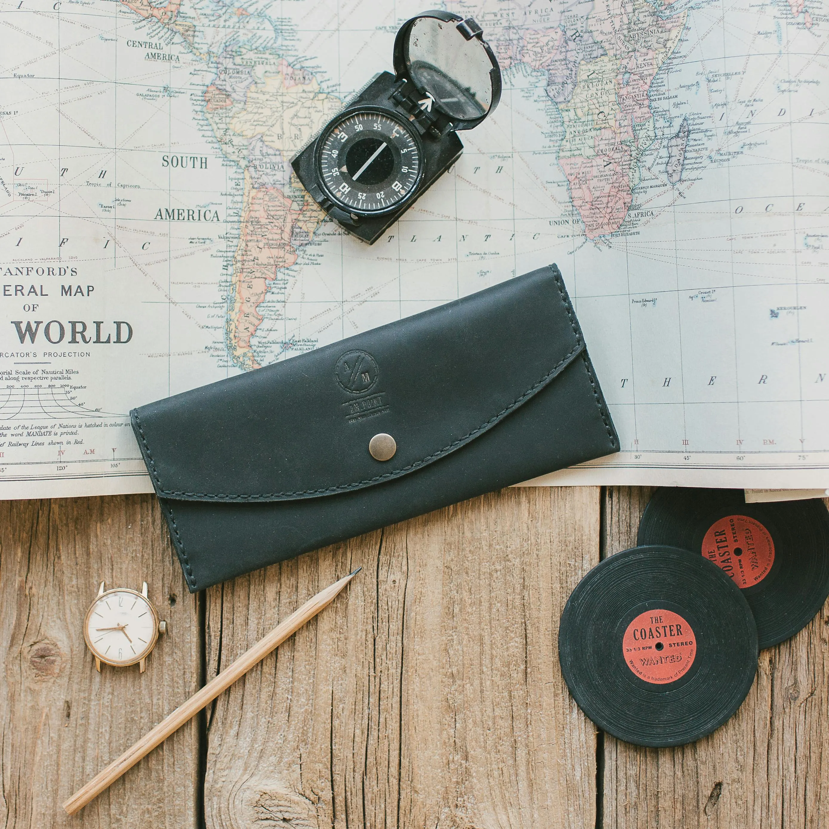 Passport, map and muted teal luggage tag on a clean travel desk