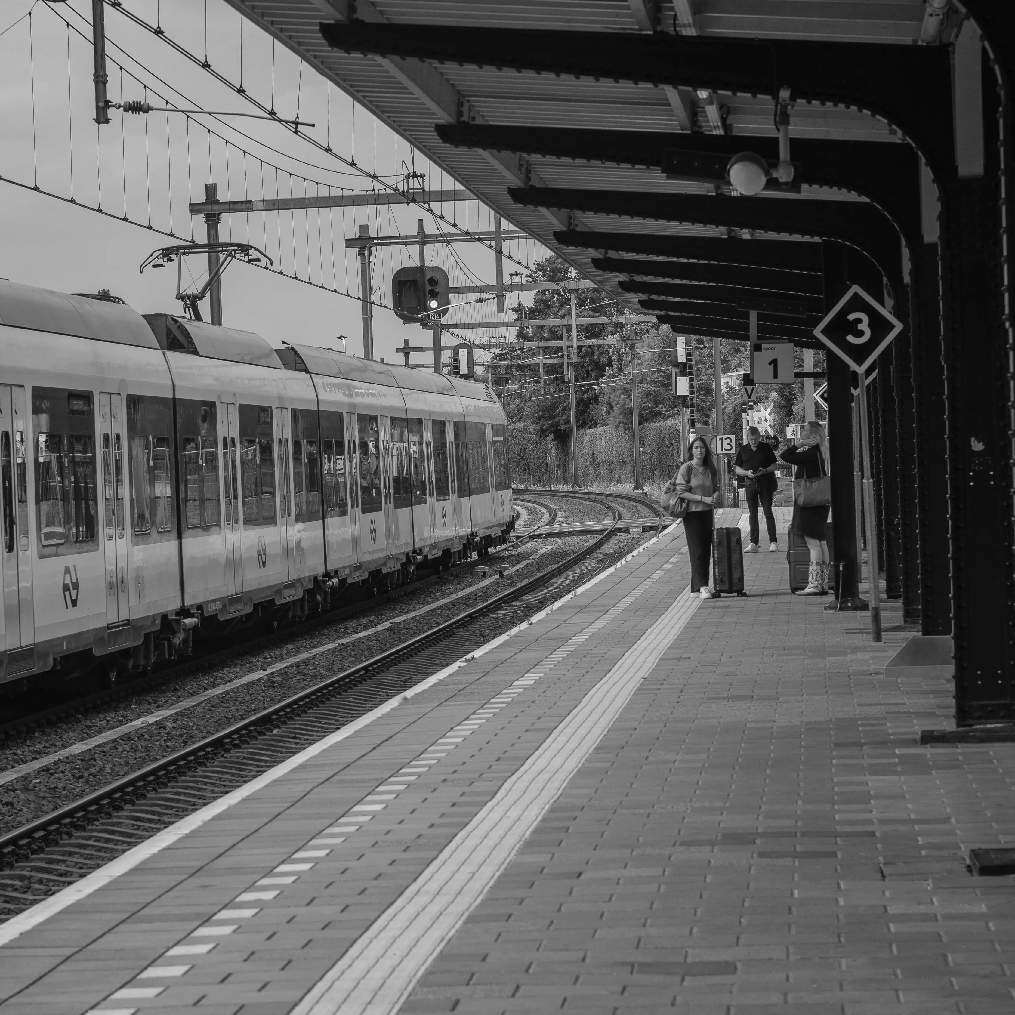 Traveller with light luggage on a quiet station platform