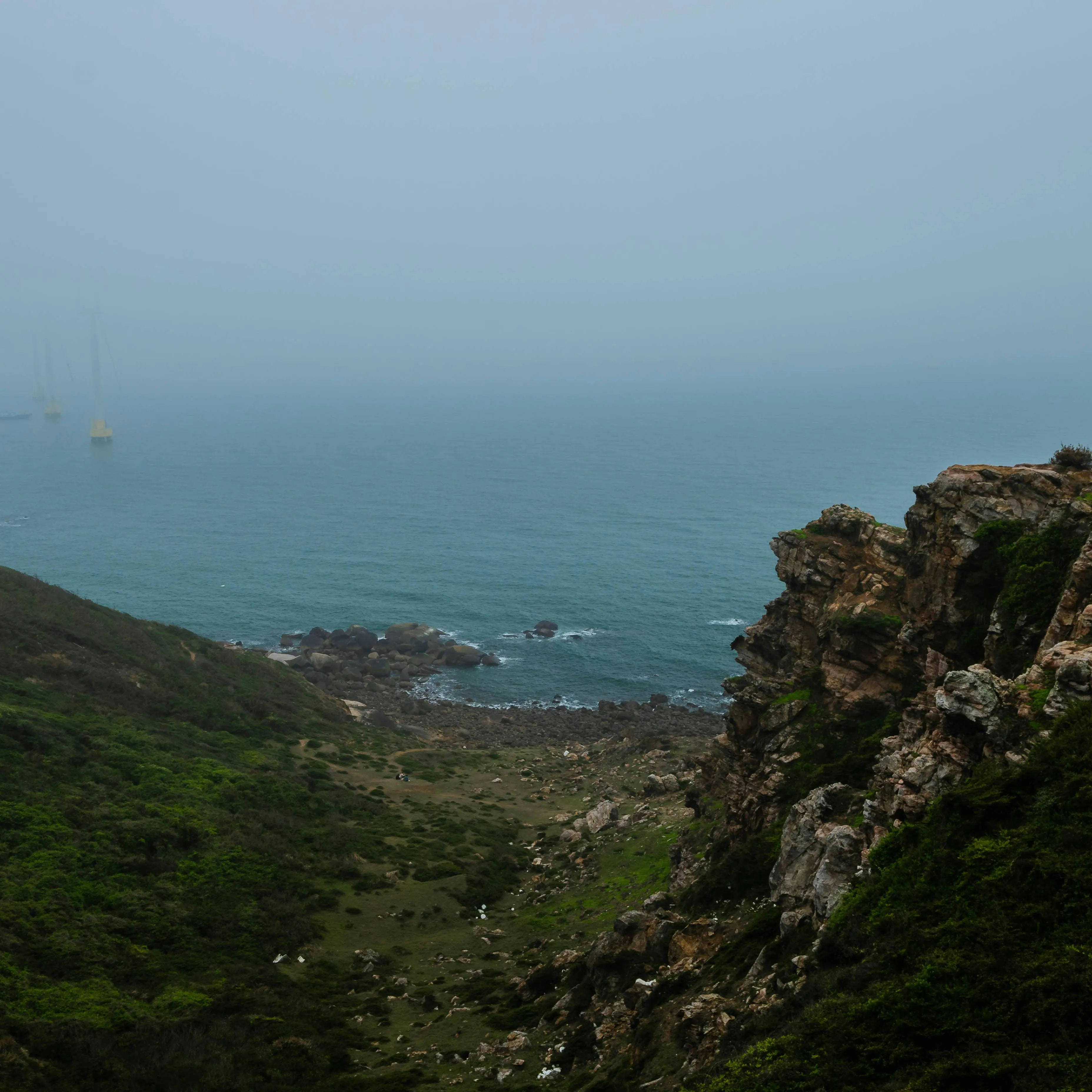 Minimal coastal road journey with misty cliffs and pale Nordic colour palette