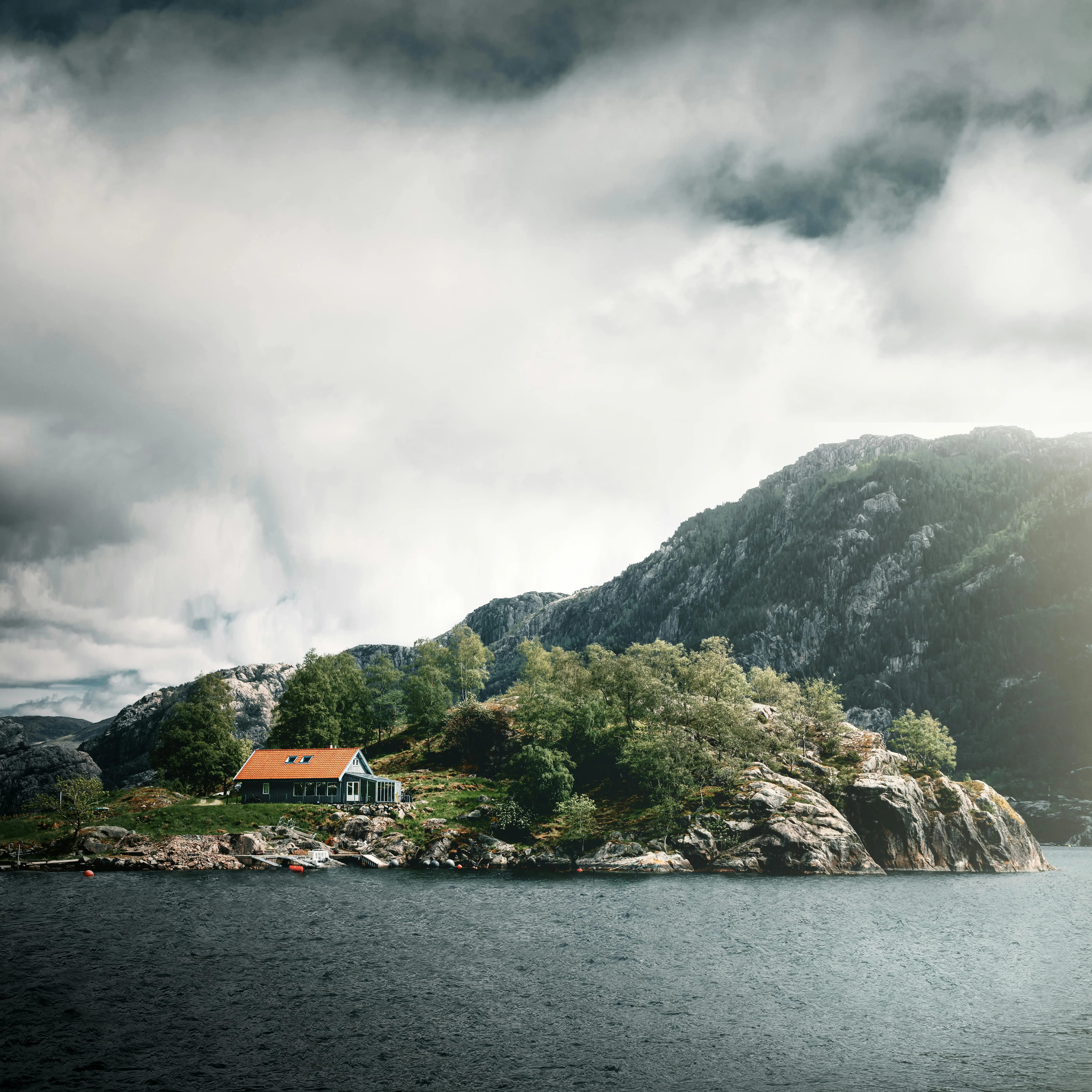 Quiet fjord landscape with pale sky and calm water for Nordic styled worldwide travel