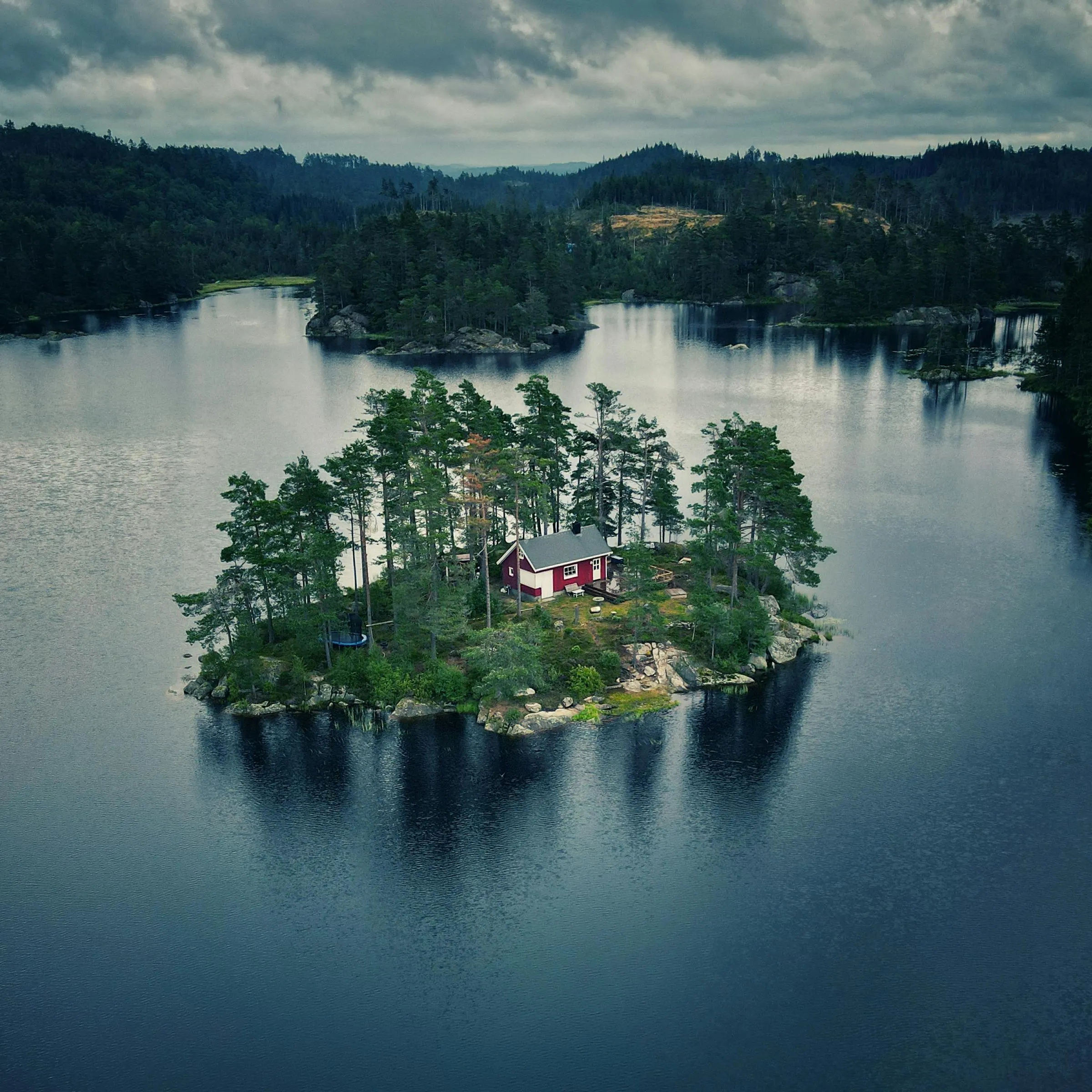 Cabin retreat beside a quiet lake with frost coloured Nordic travel atmosphere